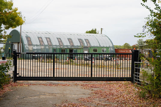 Black cantilever sliding gate at a farm yard