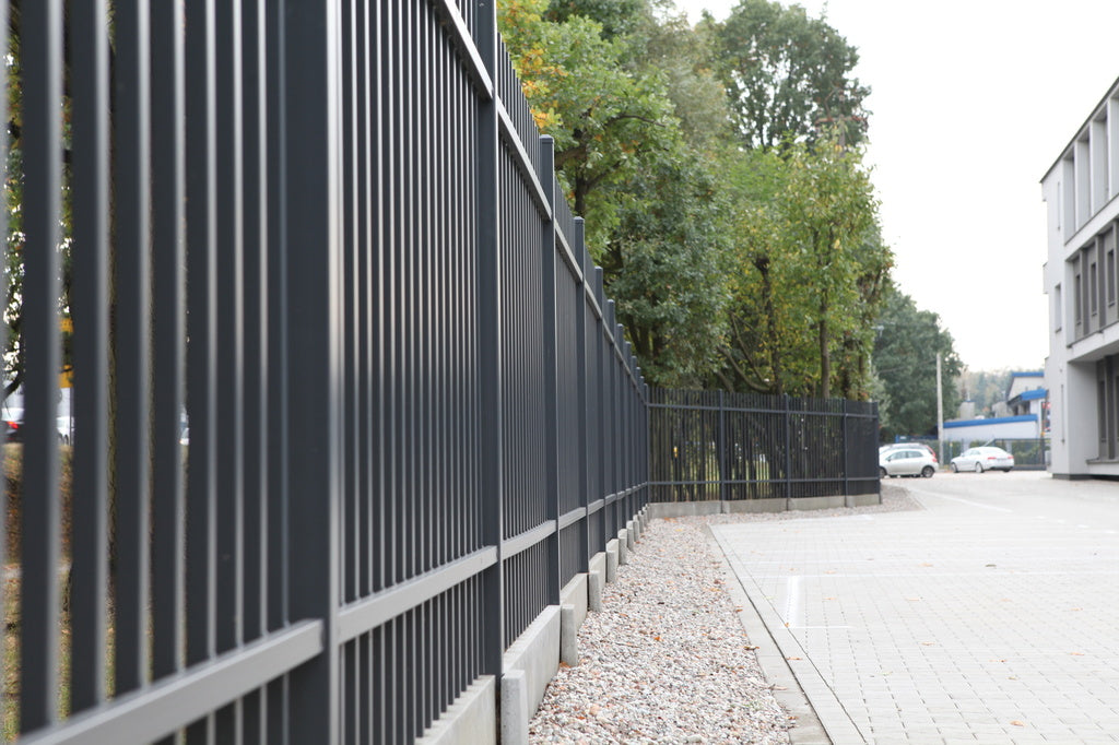 Black mesh panel security fencing along a commercial boundary