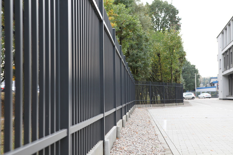 Black mesh panel security fencing along a commercial boundary