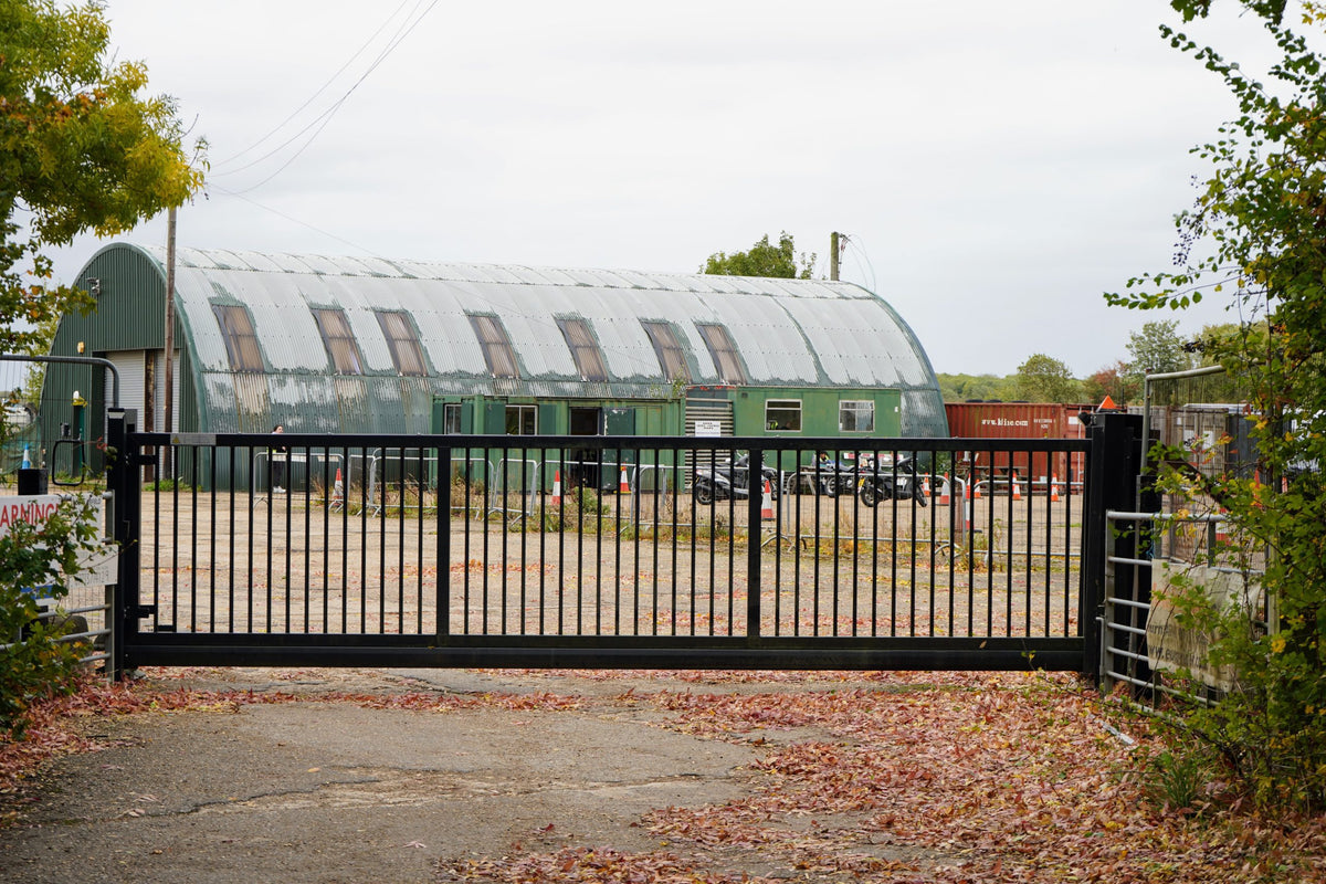 Black cantilever sliding gate at a farm yard