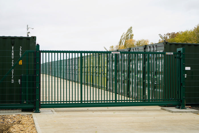 Green mesh cantilever sliding gate at a commercial site
